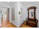 Welcoming entryway with hardwood floors and antique mirror, creating an inviting space at 515 Houze Way, Roswell, GA 30076