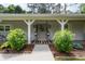 Charming front entrance with covered porch and manicured landscaping at 515 Houze Way, Roswell, GA 30076