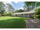 Ranch home with a sprawling front yard, manicured landscaping and covered front porch at 515 Houze Way, Roswell, GA 30076