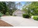 Spacious two-car garage with extra parking space and lush landscaping at 515 Houze Way, Roswell, GA 30076