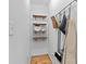 Functional hallway with wooden shelves, mounted mirror, and hanging rack storage at 515 Houze Way, Roswell, GA 30076