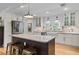 Modern kitchen with island, granite countertops, stainless appliances, and ample cabinet space at 515 Houze Way, Roswell, GA 30076
