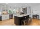 Bright, modern kitchen features a large island, stainless steel appliances, and beautiful countertops at 515 Houze Way, Roswell, GA 30076