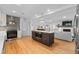 Open kitchen featuring a central island, stainless steel appliances, and seamless flow to the living area at 515 Houze Way, Roswell, GA 30076