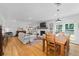 Open-concept living and dining area with hardwood floors, fireplace, and natural light at 515 Houze Way, Roswell, GA 30076