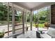 Screened-in sunroom with tile flooring and view of outdoor patio and landscaped backyard at 515 Houze Way, Roswell, GA 30076