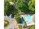 Aerial view of a community pool surrounded by lush trees and ample parking at 6359 Wedgeview Dr, Tucker, GA 30084