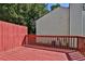 Spacious red painted wooden back deck is ideal for outdoor entertaining and relaxation at 6359 Wedgeview Dr, Tucker, GA 30084