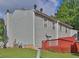 Exterior view of home featuring a well maintained backyard and red painted back deck at 6359 Wedgeview Dr, Tucker, GA 30084