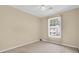 Bright bedroom with a window, ceiling fan, and neutral colored walls and carpet at 6359 Wedgeview Dr, Tucker, GA 30084