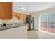 Well-lit kitchen features stainless steel refrigerator, lots of cabinet space, and sliding doors to the deck at 6359 Wedgeview Dr, Tucker, GA 30084