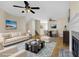Cozy living room with stylish furnishings, ceiling fans, and a fireplace feature creating an inviting atmosphere at 6359 Wedgeview Dr, Tucker, GA 30084