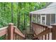Exterior view of wooden deck, featuring stairs down to ground level and serene backyard setting at 1763 Benningfield Sw Dr, Marietta, GA 30064