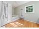 Relaxing bathroom featuring a soaking tub, hardwood floors, and a tranquil ambiance at 1763 Benningfield Sw Dr, Marietta, GA 30064