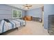 This bedroom has a bed, dresser, and ceiling fan at 1763 Benningfield Sw Dr, Marietta, GA 30064
