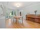 Dining room with wood floors, bay window, piano, and chandelier at 1763 Benningfield Sw Dr, Marietta, GA 30064