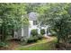 View of rear exterior showing walkout basement access and mature trees at 1763 Benningfield Sw Dr, Marietta, GA 30064