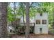 Back of house with wooden decks surrounded by lush greenery and mature trees at 1763 Benningfield Sw Dr, Marietta, GA 30064