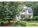 Home exterior surrounded by lush trees and colorful landscaping at 1763 Benningfield Sw Dr, Marietta, GA 30064