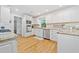 Bright, updated kitchen features white cabinets, stainless steel appliances, and hardwood flooring at 1763 Benningfield Sw Dr, Marietta, GA 30064
