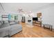 Comfortable living room with hardwood floors, a gray sofa, and a traditional fireplace at 1763 Benningfield Sw Dr, Marietta, GA 30064