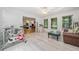 Bright living room featuring hardwood floors, three windows, and cozy seating, perfect for relaxation and entertainment at 1763 Benningfield Sw Dr, Marietta, GA 30064