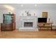 Living room featuring hardwood floors, a traditional fireplace, and wooden furniture at 1763 Benningfield Sw Dr, Marietta, GA 30064