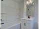 A bright bathroom featuring a white tub and shower combination with modern fixtures and a vanity at 1923 Deco Dr, Kennesaw, GA 30144