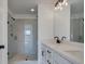 Bathroom showcases a glass-enclosed shower and double vanity with modern fixtures and lighting at 1923 Deco Dr, Kennesaw, GA 30144