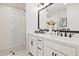 Modern bathroom featuring double sinks, white cabinets, and a glass enclosed shower at 1923 Deco Dr, Kennesaw, GA 30144