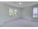 Bright bedroom with plush carpeting and large windows offering plenty of natural light at 1923 Deco Dr, Kennesaw, GA 30144