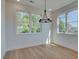 Sunlit dining area featuring large windows, hardwood floors, and a modern chandelier at 1923 Deco Dr, Kennesaw, GA 30144