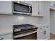 Sleek kitchen featuring stainless steel appliances, white countertops, and modern fixtures at 1923 Deco Dr, Kennesaw, GA 30144