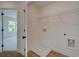 Bright laundry room with hardwood flooring, white walls, and wire shelving for organized storage solutions at 1923 Deco Dr, Kennesaw, GA 30144