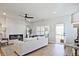 Bright living room with hardwood floors, a ceiling fan, and a cozy fireplace, enhancing the inviting atmosphere at 1923 Deco Dr, Kennesaw, GA 30144