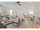 Comfortable living room with fan, neutral colors, wood floors, and view into the kitchen at 1923 Deco Dr, Kennesaw, GA 30144