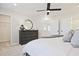 Comfortable main bedroom featuring a dresser, soft carpet, a ceiling fan, and ensuite bathroom access at 1923 Deco Dr, Kennesaw, GA 30144
