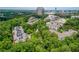 Community aerial view of condominium surrounded by trees and nearby buildings at 3280 Stillhouse Se Ln # 401, Atlanta, GA 30339