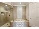 Elegant bathroom featuring a soaking tub and walk-in shower at 3280 Stillhouse Se Ln # 401, Atlanta, GA 30339