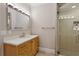 Bathroom featuring a wooden vanity with quartz countertop and a glass shower at 3280 Stillhouse Se Ln # 401, Atlanta, GA 30339