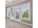 Bright bedroom features large glass doors and windows with natural light and tree views at 3280 Stillhouse Se Ln # 401, Atlanta, GA 30339