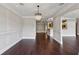 Dining room with decorative chandelier, panel molding, and stained wood floor at 3280 Stillhouse Se Ln # 401, Atlanta, GA 30339