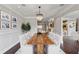 Formal dining room features decorative lighting, panel molding, and view to kitchen at 3280 Stillhouse Se Ln # 401, Atlanta, GA 30339
