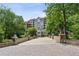 Elegant condominium building with a stone bridge entrance and lush green landscaping at 3280 Stillhouse Se Ln # 401, Atlanta, GA 30339