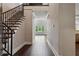 Spacious foyer with wood floors and staircase leading to the upper level at 3280 Stillhouse Se Ln # 401, Atlanta, GA 30339