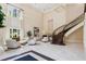 Grand foyer with soaring ceilings, curved staircase, marble floors, and elegant seating area at 3280 Stillhouse Se Ln # 401, Atlanta, GA 30339