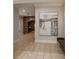 Hallway featuring a stone archway, art on the walls, and light tile floors at 3280 Stillhouse Se Ln # 401, Atlanta, GA 30339