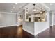 Open-concept kitchen with breakfast bar, hardwood floors, and recessed lighting at 3280 Stillhouse Se Ln # 401, Atlanta, GA 30339