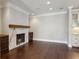 Open living room with marble fireplace and stained wood floor at 3280 Stillhouse Se Ln # 401, Atlanta, GA 30339
