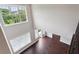 Bright living room with dark wood floors and large windows offering lush green views at 3280 Stillhouse Se Ln # 401, Atlanta, GA 30339